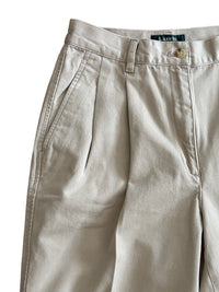 Close up of beige pants on a white background