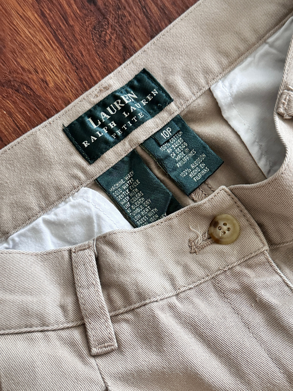 Close-up of Lauren Ralph Lauren clothing label on beige fabric.