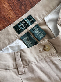 Close-up of Lauren Ralph Lauren clothing label on beige fabric.