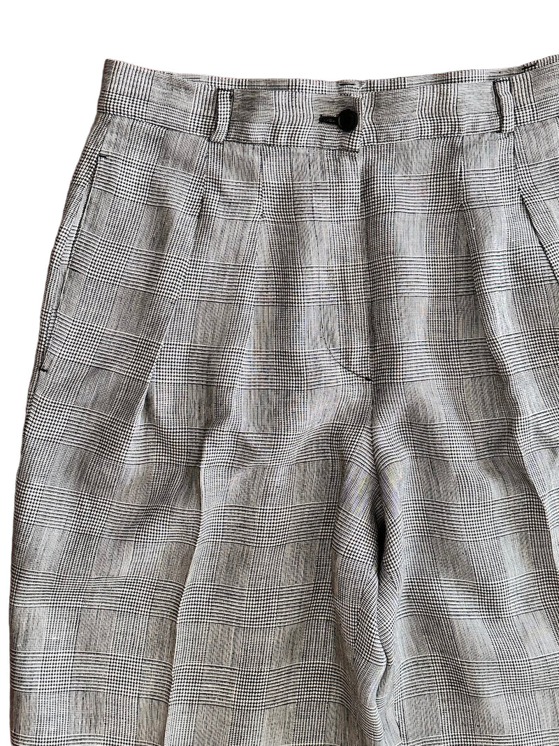 Houndstooth patterned pants on a white background