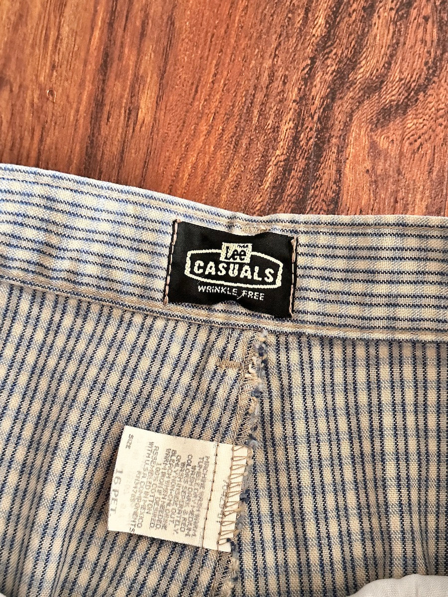 Close up of a Lee Casuals label on plaid trousers on a wooden surface