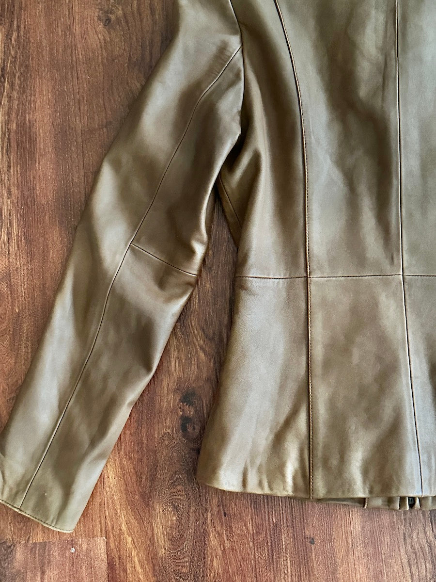 Closeup of a brown leather jacket on a wooden surface