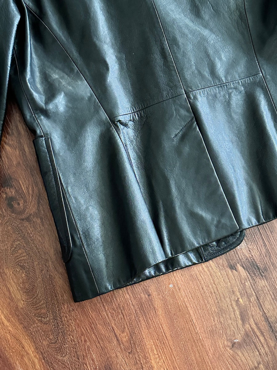Closeup of a  black leather jacket on a wooden surface
