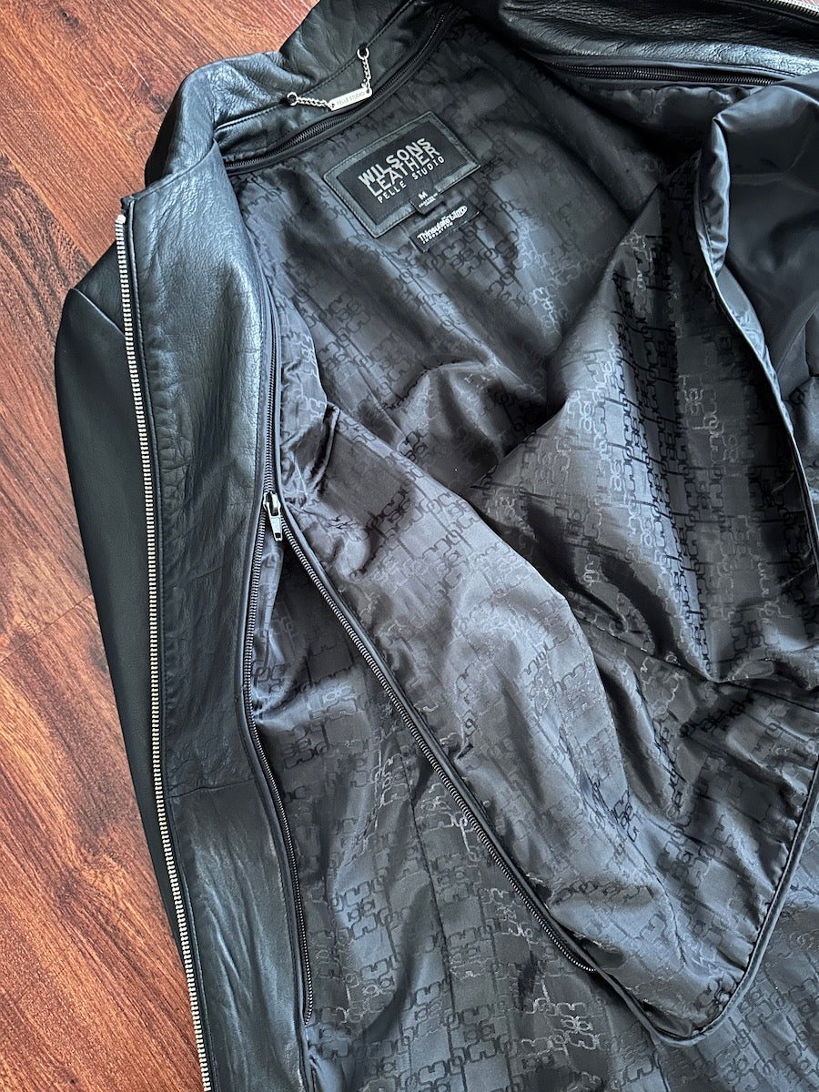 Black jacket with a brand logo on a wooden surface