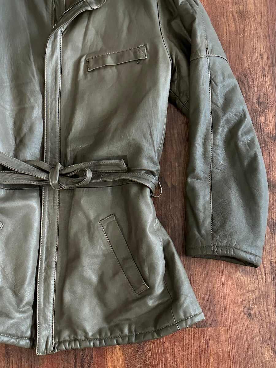 Taupe leather jacket with a belt on a wooden surface