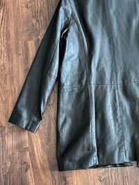 Chocolate brown leather jacket on a wooden surface