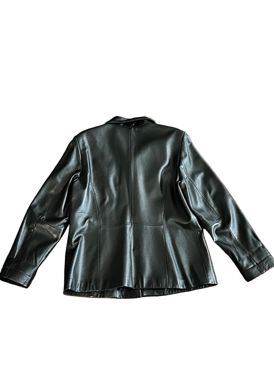 Backside of a black leather jacket on a white background