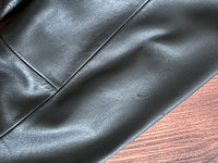 Close-up of black leather fabric on a wooden surface