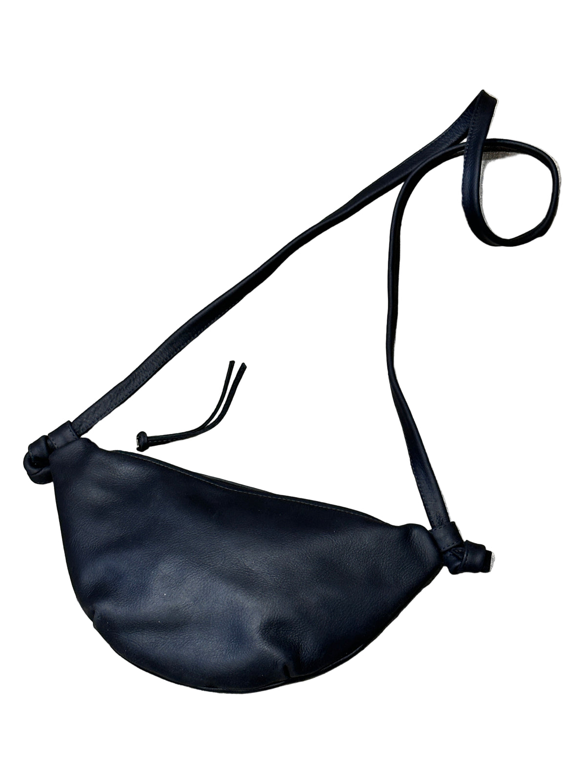 Black crossbody bag on a textured surface