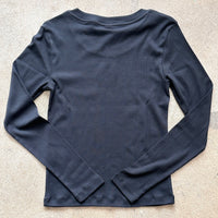 Black long-sleeve shirt on a light gray background