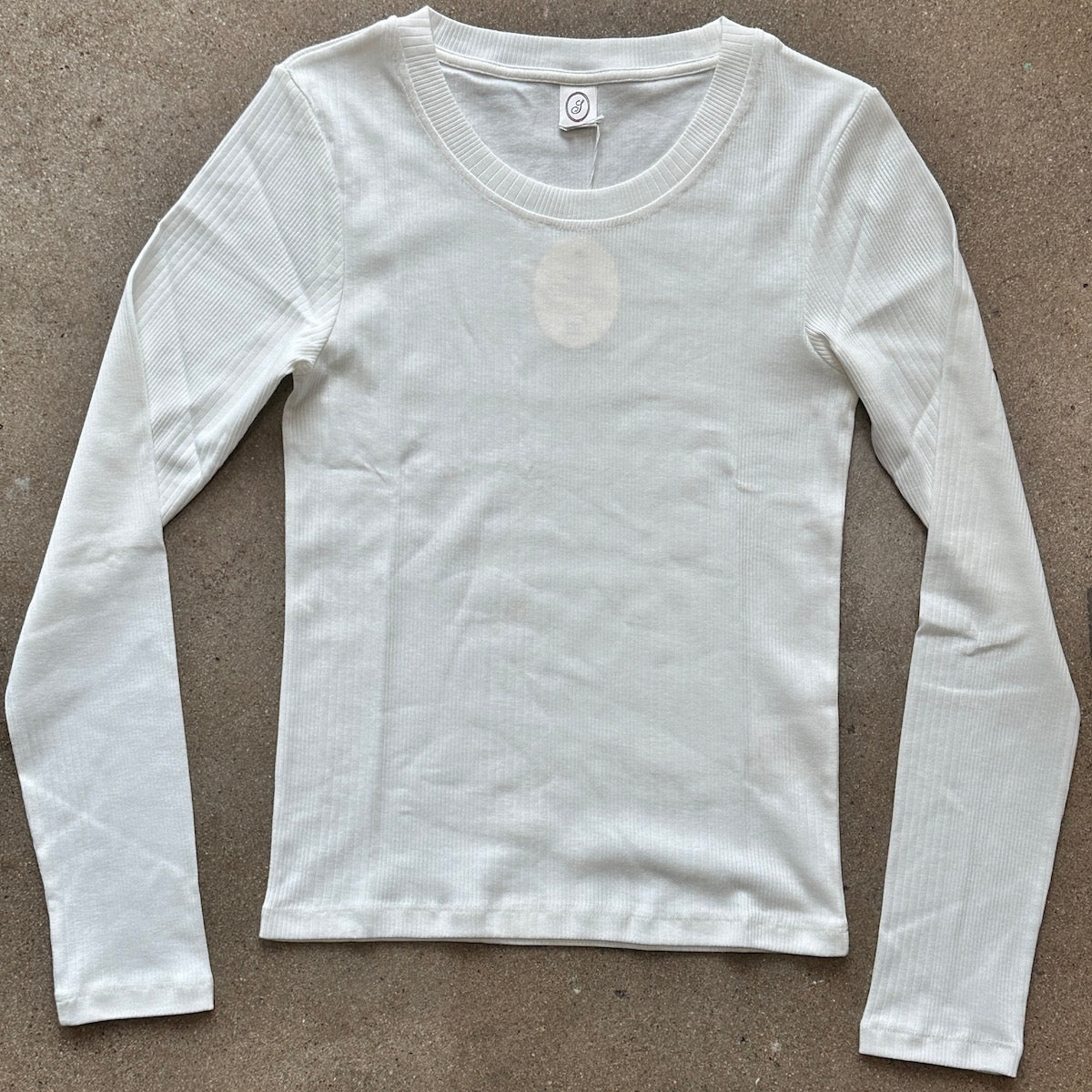 White long-sleeve shirt on a brown background