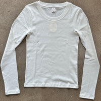 White long-sleeve shirt on a brown background