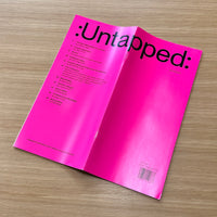Open magazine titled 'Untapped' on a wooden surface