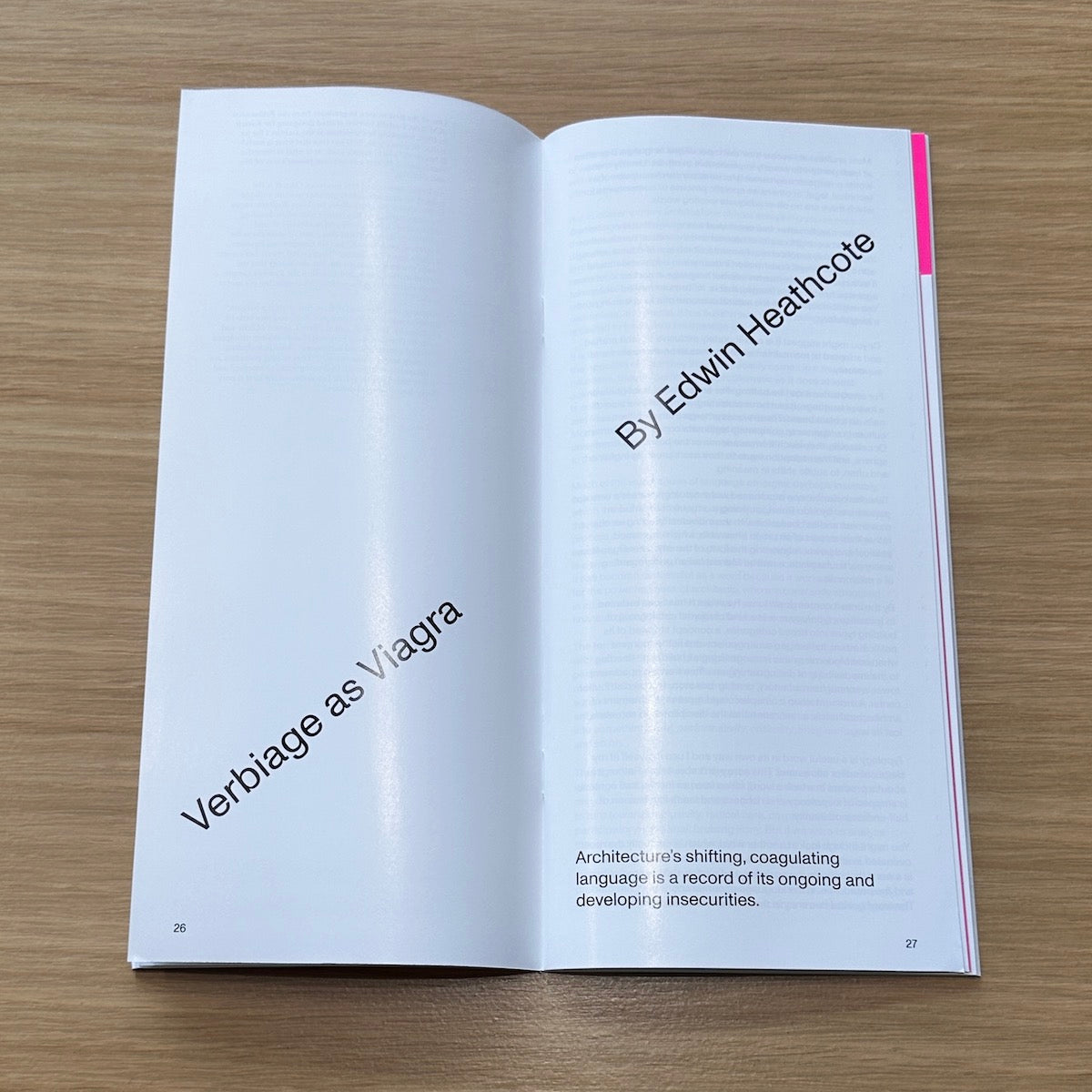 Open magazine on a wooden surface with text about 'Verbiage as Viagra' by Edwin Heathcote.