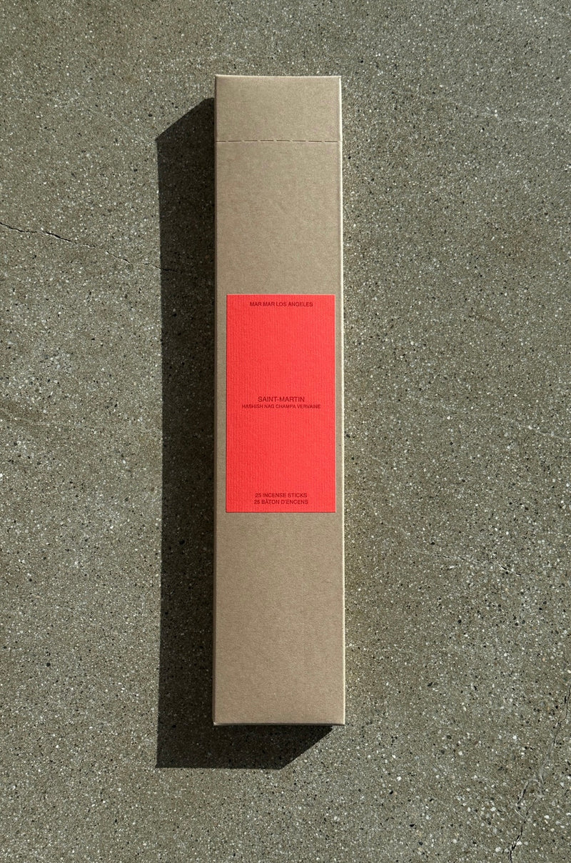 Cardboard box of incense with red label on a concrete surface