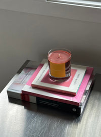 Candle on a stack of books with a minimal background