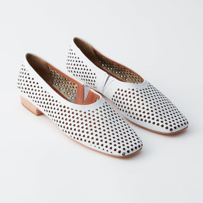 White perforated flats on a light gray background