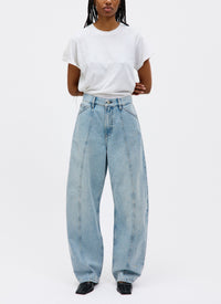 Person wearing light blue jeans and a white t-shirt on a white background