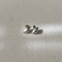 Pair of silver earrings on a light fabric background