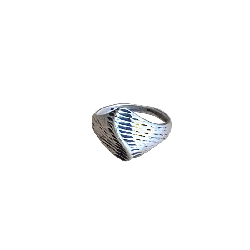 Silver ring with a textured design on a white background