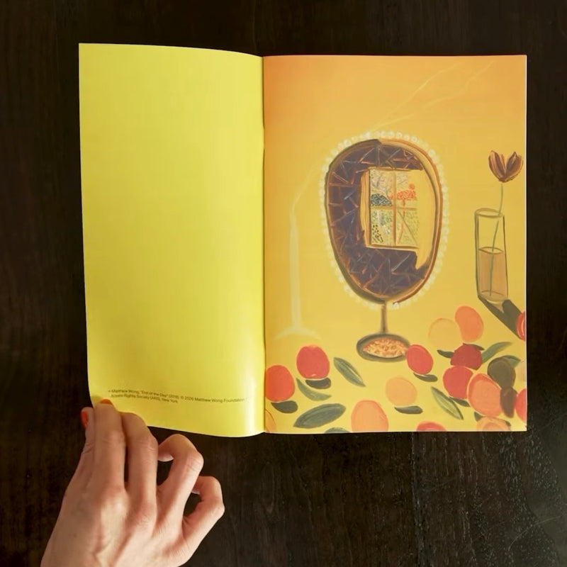 Open magazine with a colorful illustration of a cocktail glass and fruit on a yellow background.