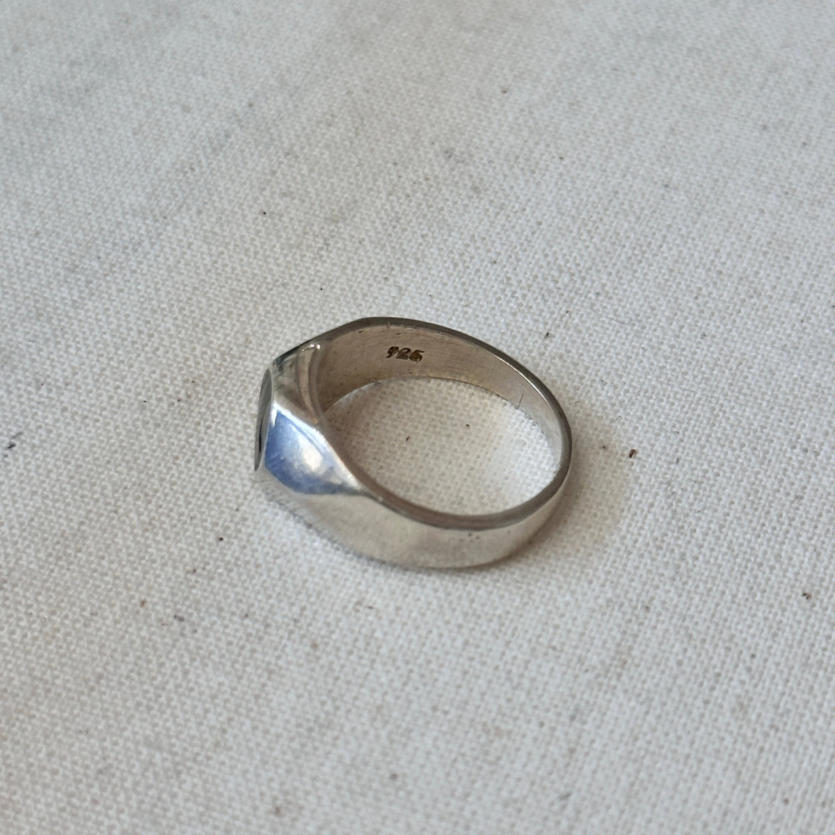 Silver ring on a textured gray surface