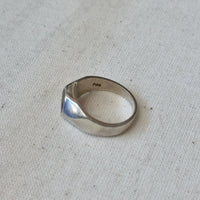 Silver ring on a textured gray surface