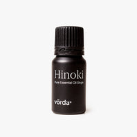 Black bottle labeled 'Hindi Pure Essential Oil Single' and 'vörda' with a ribbed cap on a light grey background