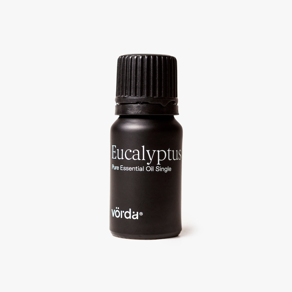 A small black bottle of Vörda Eucalyptus Plus Essential Oil Single, featuring a ribbed black cap and white text, set against a clean white background.
