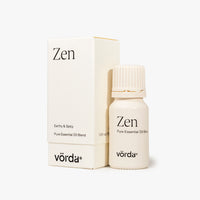 Zen Pure Essential Oil Blend by vörda, shown as a small cream-colored bottle next to its matching cream-colored packaging box on a light gray background.