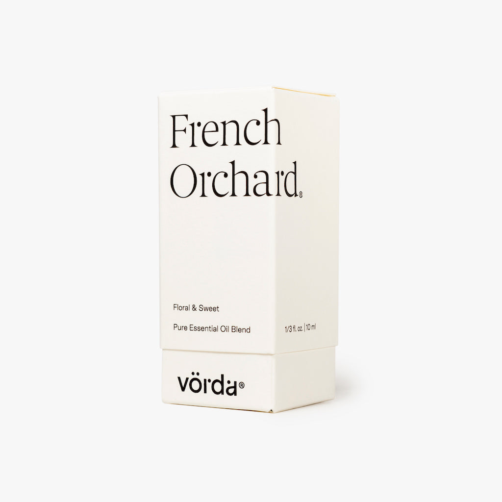 A white rectangular box for Vörda French Orchard essential oil, featuring black text on a clean white background.