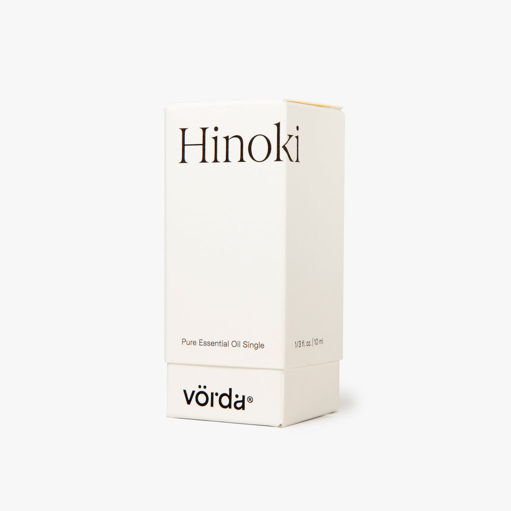 A white rectangular box for Vörda Hinoki pure essential oil single, featuring black text on a clean white background.
