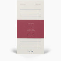 Notepad with a red label and 'NOTEM' branding on a white background