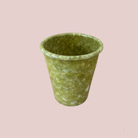green marbled pen cup on a light pink background