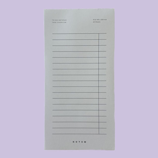 Notepad with lined pages on a light purple background