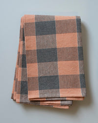 Folded plaid blanket with orange and blue pattern 