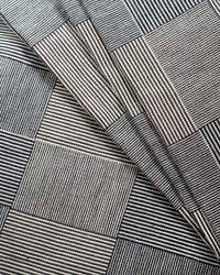 Close-up of a textured blanket with a striped, checkered pattern