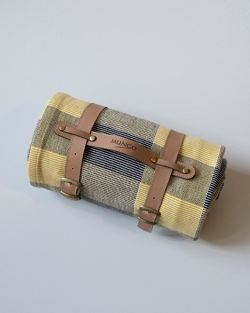 Roll-up picnic blanket with brown leather straps 