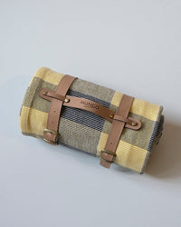 Roll-up picnic blanket with brown leather straps 