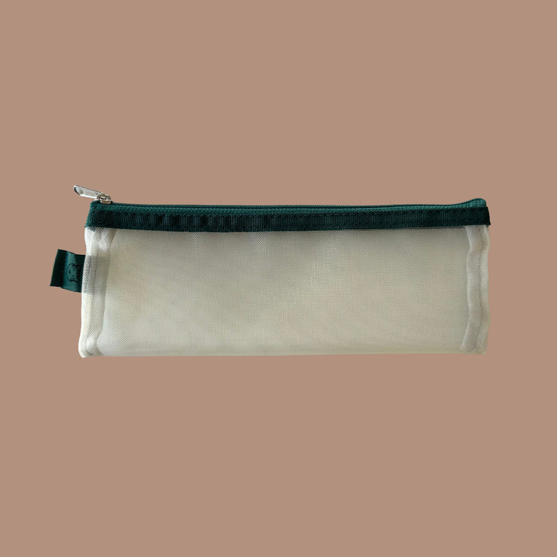 Yellow pouch with green zipper on a beige background