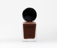 Brown nail polish bottle with black cap on a white background