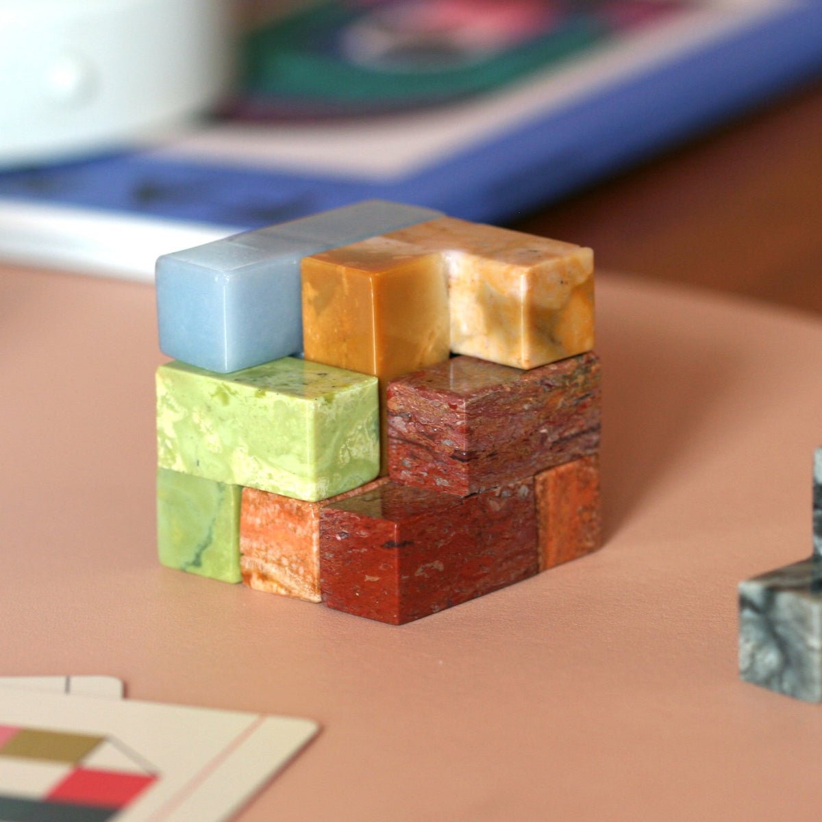 Stack of colorful stone blocks on a table with a blurred background