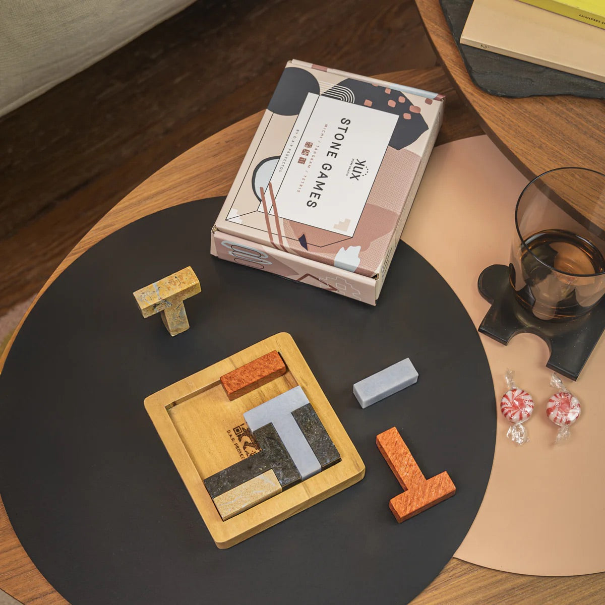 puzzle game with pieces on a table, featuring a box labeled 'Stone Games'.