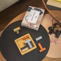puzzle game with pieces on a table, featuring a box labeled 'Stone Games'.