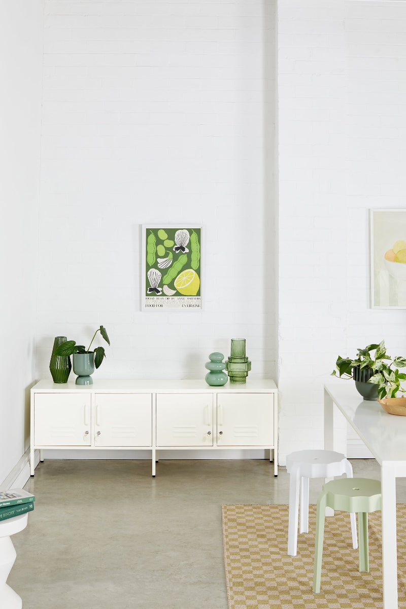 Modern interior with white furniture, green decor, and a light gray floor.