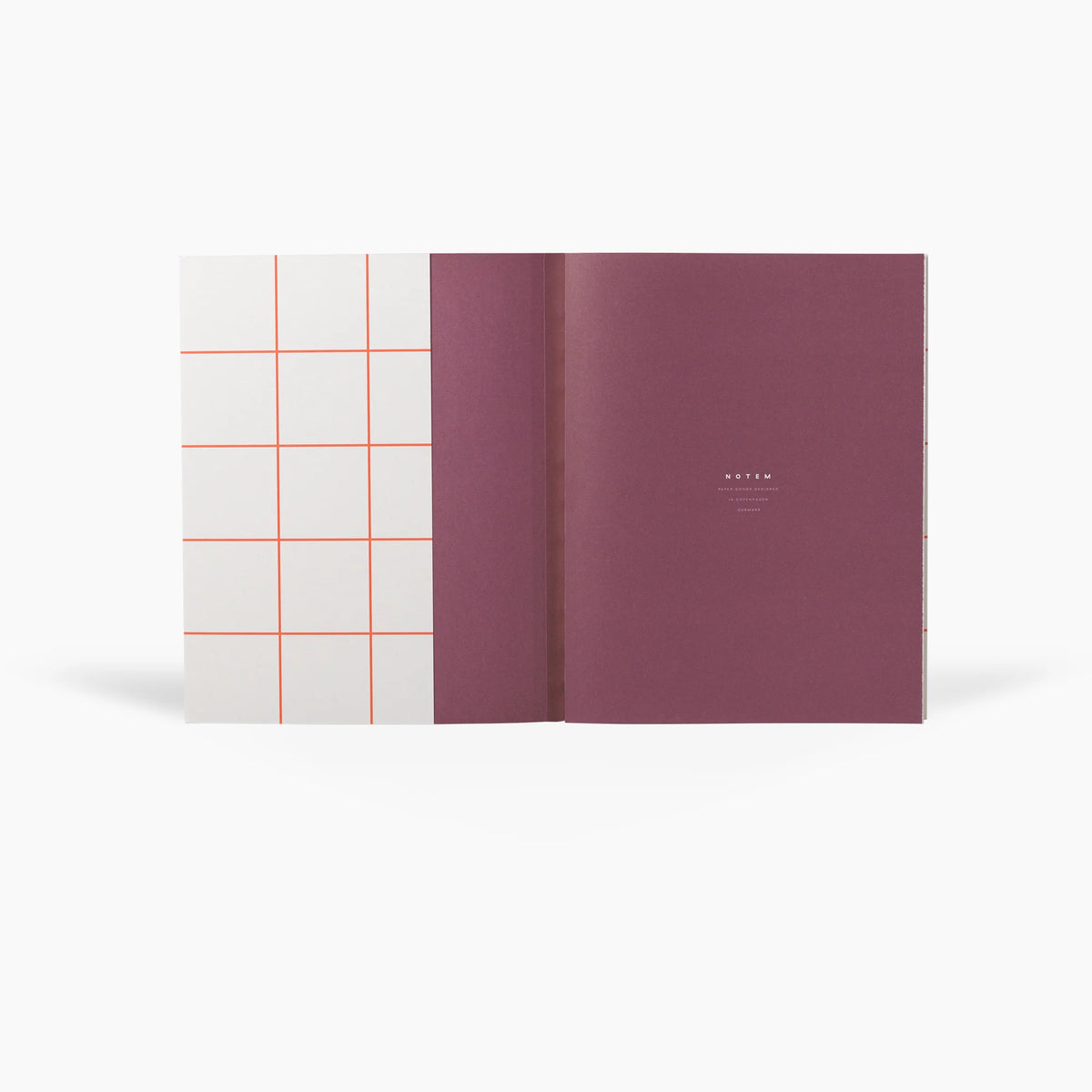 Two notebooks, one with a grid pattern cover and the other solid color, on a white background.