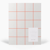 Notebook with red grid lines on a white background