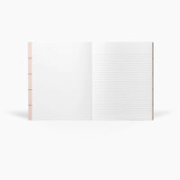 White notebook with a pink cover on a white background