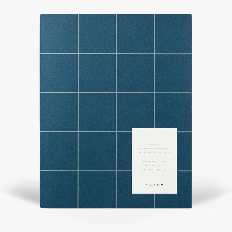 Blue grid-patterned notebook with a white label on a white background