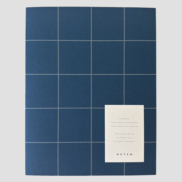 Blue grid pattern notebook with a white card displaying text on a gray background